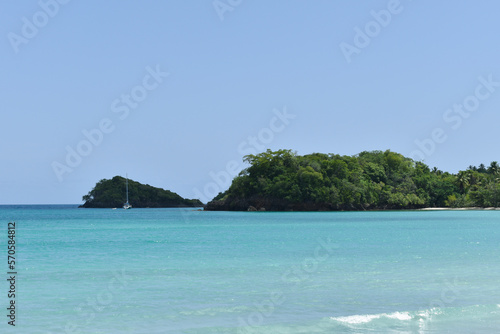 Beautiful bay with a sailing boat on the Caribbean beach. Terrenas, Samana Bay, Dominican Republic. photo