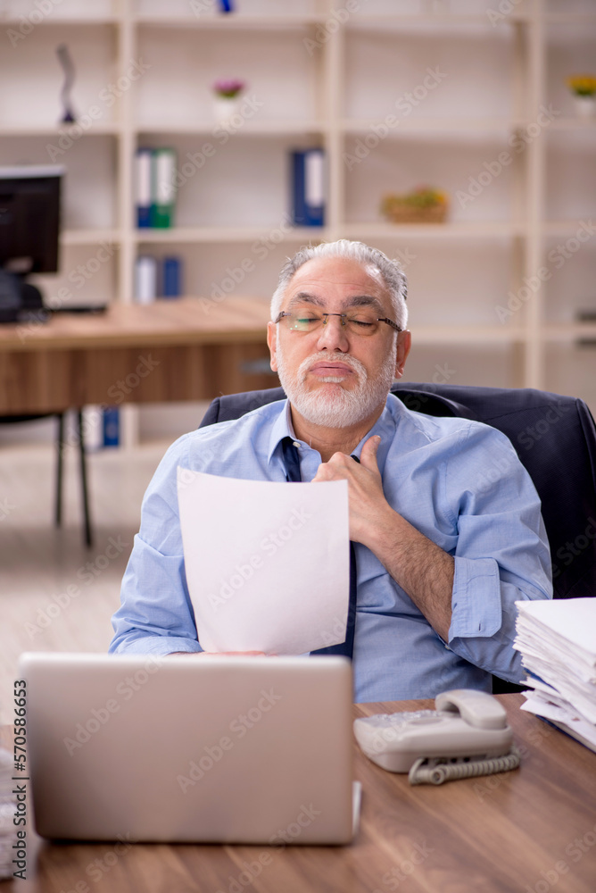 Old male employee and too much work in the office Old male employee and too much work in the office