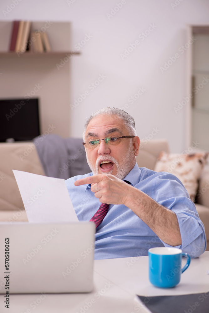 Old male employee working from home during pandemic Old male employee working from home during pandemic