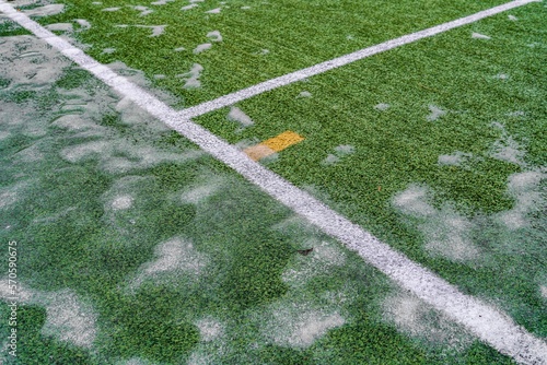 Close-up view of frozen football field grass in winter