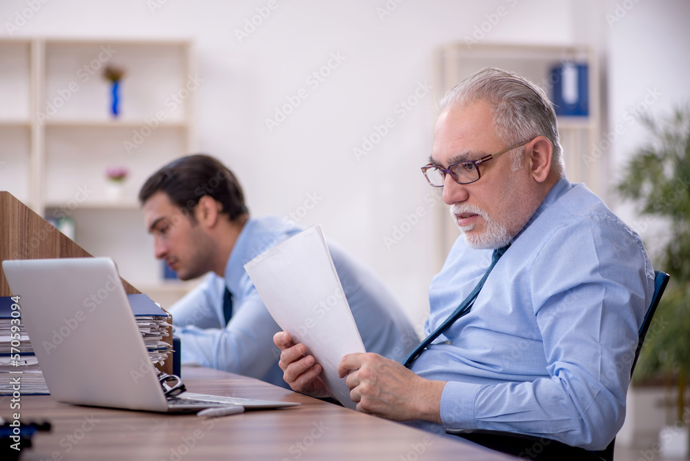 Two male colleagues working in the office Two male colleagues working in the office