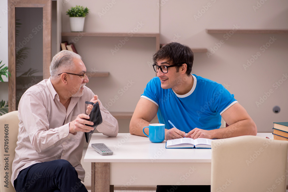 Young male student and his grandfather at home Young male student and his grandfather at home