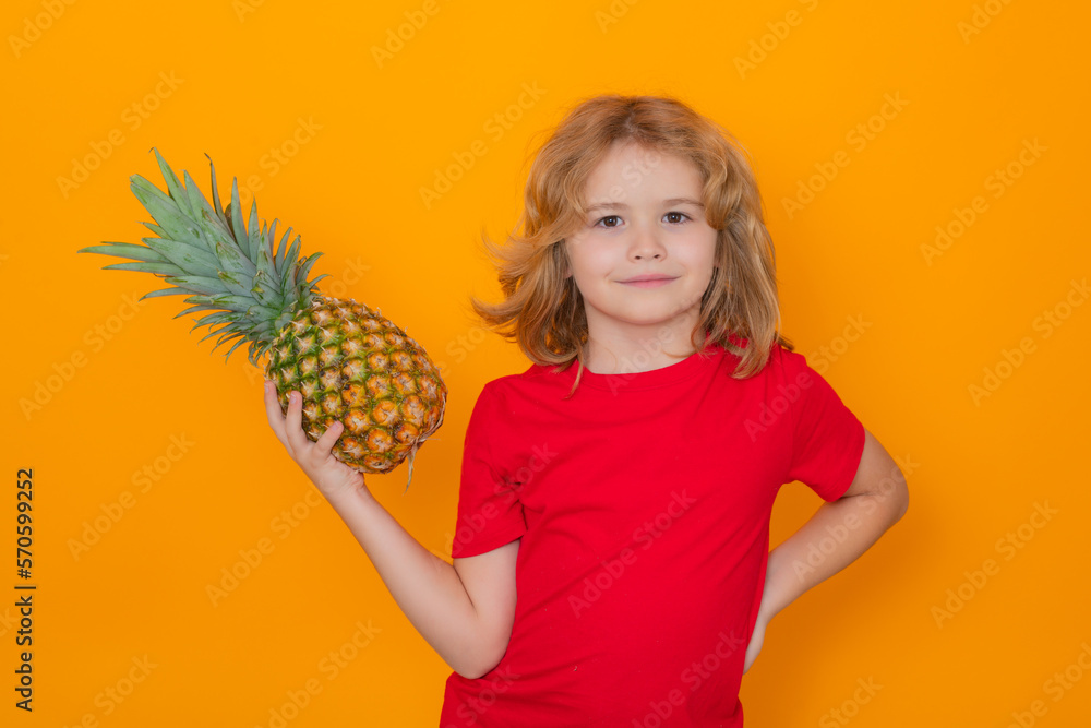 Kid with pineapple in studio. Studio portrait of cute child hold pineapple isolated on yellow background. Kid with pineapple in studio. Studio portrait of cute child hold pineapple isolated on yellow background.