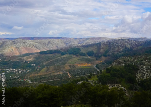 Fototapeta Naklejka Na Ścianę i Meble -  umm qais - irbid, jordan 06- Feb- 2023 - green rocky mountains at jordan- irbid