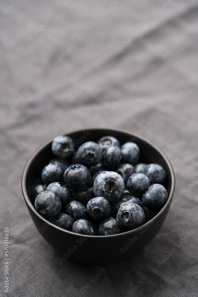 Freshly washed organic blueberries in a black bowl closeup Freshly washed organic blueberries in a black bowl closeup