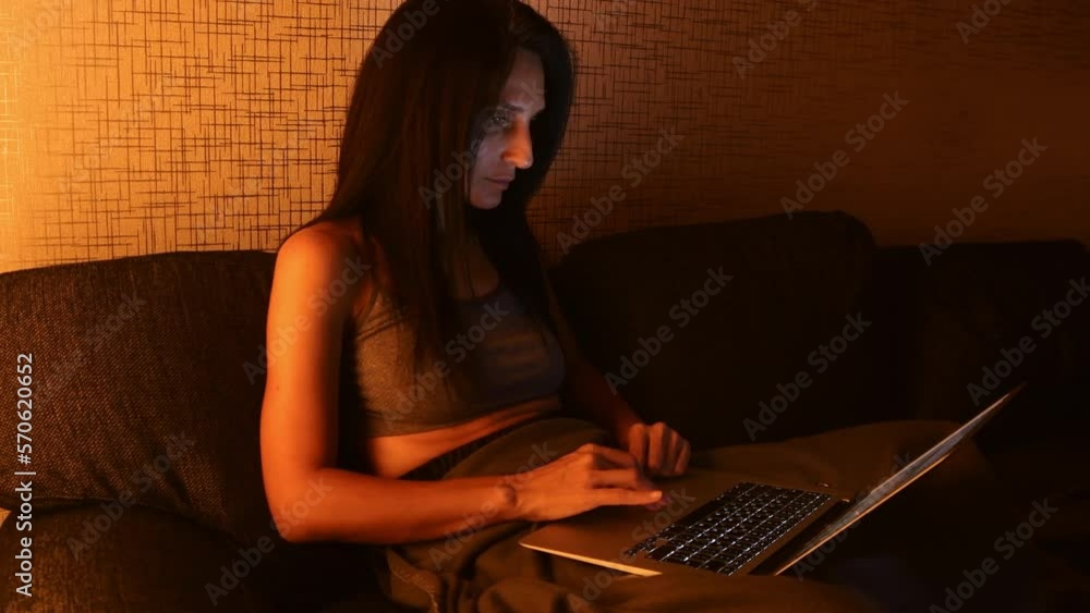 Young caucasian beautiful woman on couch work from home hold notebook browse internet, online shopping, check data. Young caucasian beautiful woman on couch work from home hold notebook browse internet, online shopping, check data.