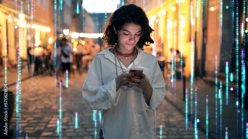 Beautiful Woman Using Smartphone on a City Street at Night. Wireless communication network concept. Visualization of the Internet by information lines flying to the global digital network