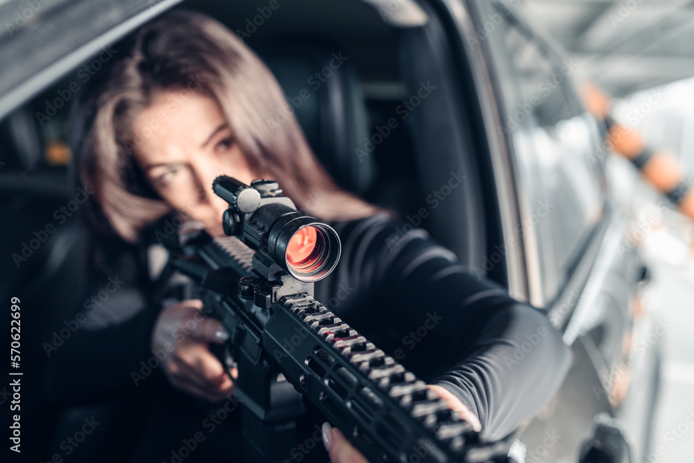 killer girl with a rifle in a car.