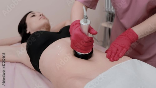 The massage therapist makes a hot vacuum massage.Shot close-up.Body care.Girl doing procedures. photo