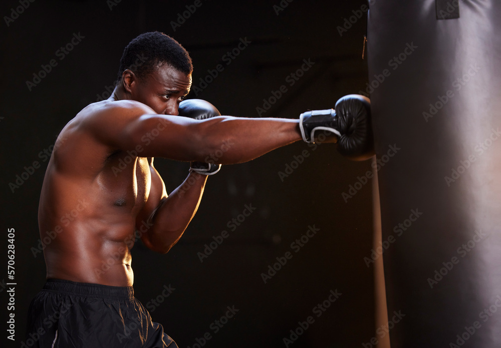 Boxing, fitness and black man isolated on a dark background or gym training and bodybuilder fist impact. Strong, power and focus of boxer, athlete or sports person with exercise, workout in mma gear