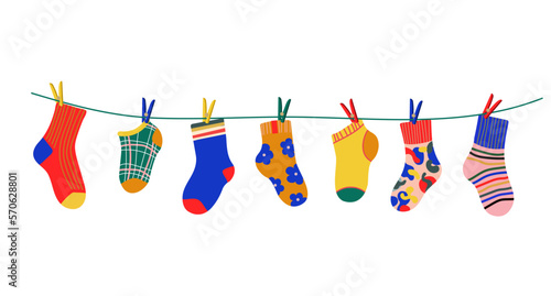 Socks on a rope with colored clothespins. Dry a cotton or wool sock and hang it on a clothesline with clothespins. Baby socks with textures and patterns vector cartoon. Illustration of woolen and cott