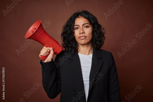 Photography A young business woman passionately advocates for her rights with a megaphone