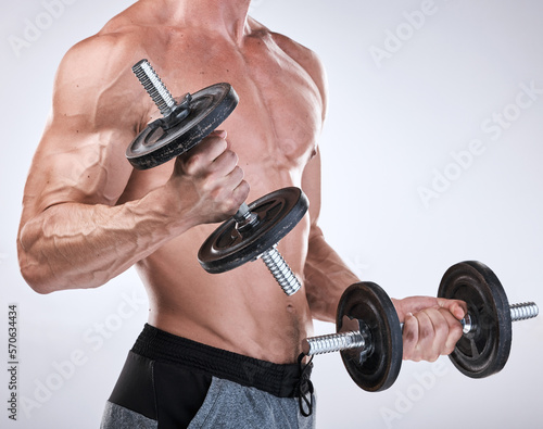 Fitness, strong or man with dumbbells in hands for exercise, training or workout for body goals. Gym motivation, sports or healthy bodybuilder weightlifting to grow biceps muscle isolated in studio photo