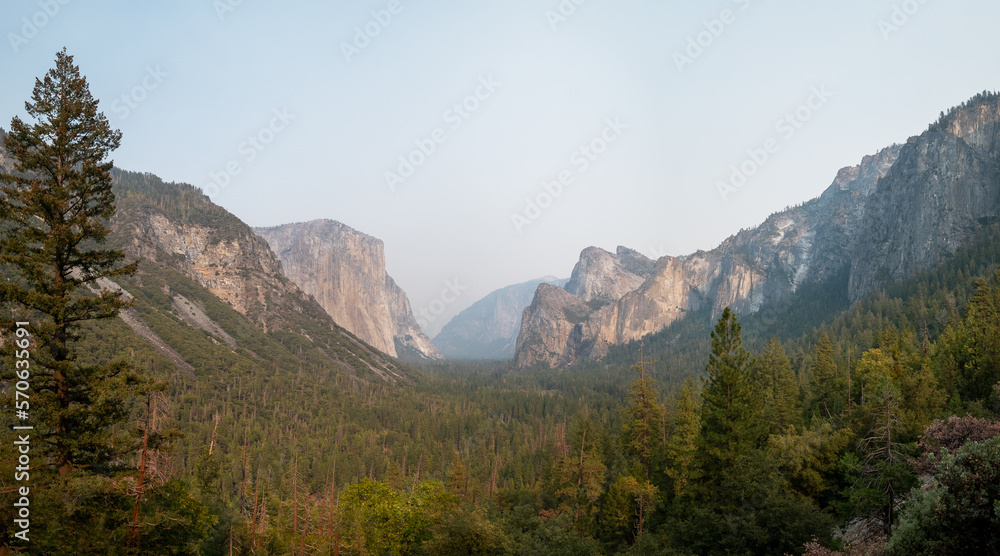 Panoramic view of Tunnel View with some smoke between the mountains, in Yosemite NP