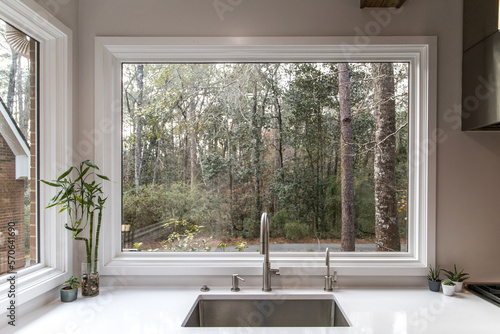 Photos A large farmhouse single farm house sink with a massive picture window with a vi