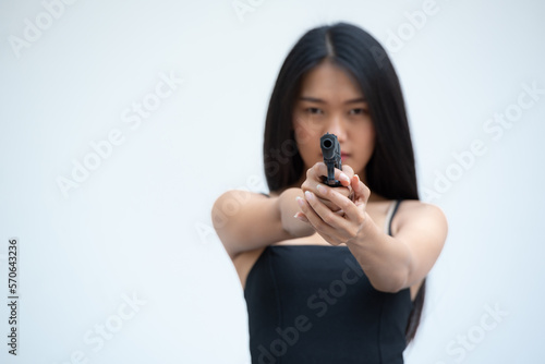 Fotografia, Obraz Sexy beauty young woman in black camisole posing with gun on white background