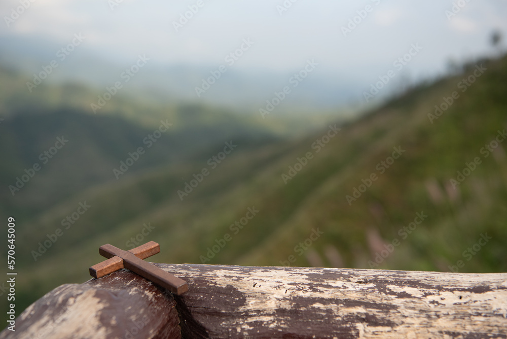 Girl praying with cross in nature sunrise background Girl praying with cross in nature sunrise background