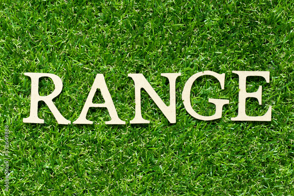 Wood letter in word range on green grass background