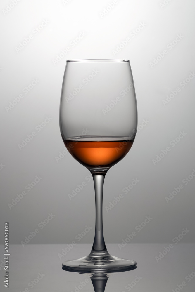 Rose wine in a glass close-up, isolated in backlight Rose wine in a glass close-up, isolated in backlight