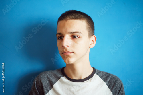 Photo of adorable young happy boy looking at camera.Isolated on the light blue background © Amir Bajric