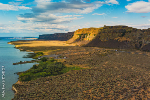 Unbelievable landscape - brown cliffs, highway, blue ocean. Amazing nature. Coulee Corridor National Scenic Byway, Eastern Washington