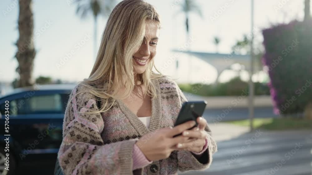 Young blonde woman smiling confident using smartphone at street Young blonde woman smiling confident using smartphone at street