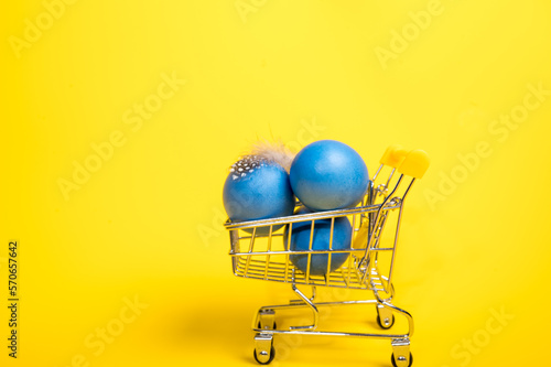 Supermarket trolley with blue easter eggs