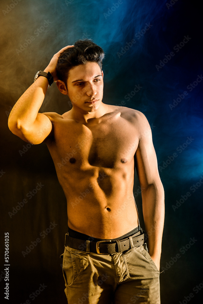 Fototapeta premium Shirtless attractive young man looking at camera in studio