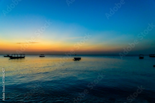 Traditional tourist boats at the Indian ocean when sunset. Zanzibar  Tanzania