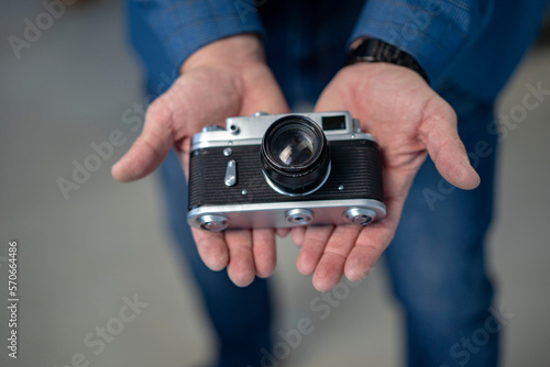 Male hands holding a vintage old camera