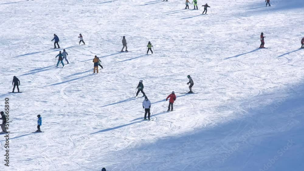 People enjoying the mountain slope at ski resort People enjoying the mountain slope at ski resort