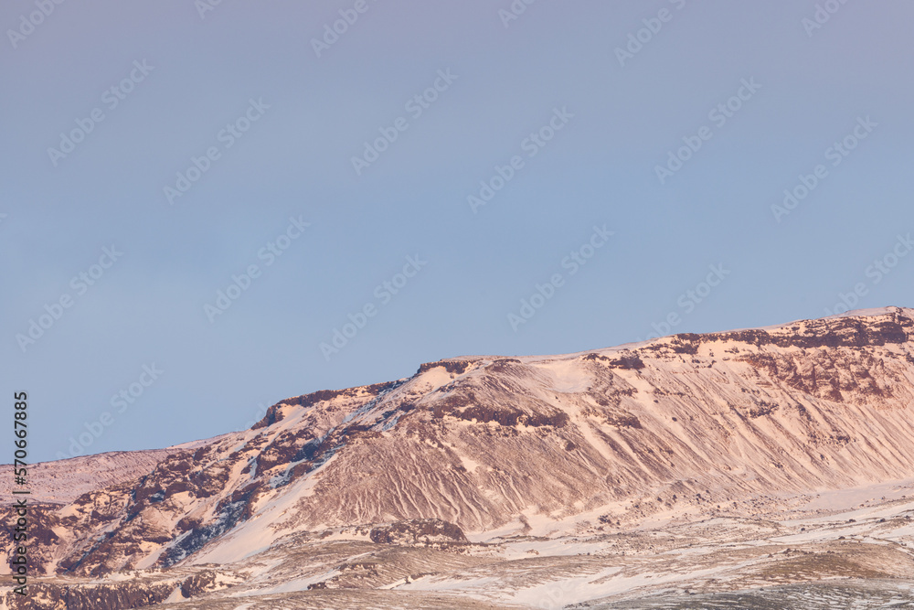 Fototapeta premium Mountain peaks in Iceland illuminated by the morning sun.
