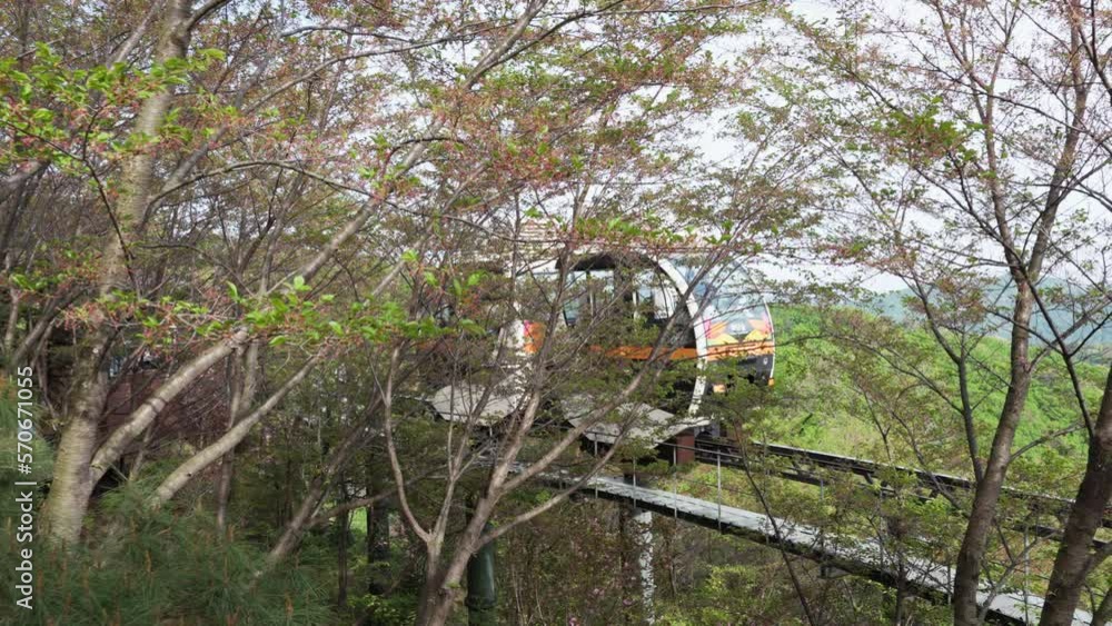 Monorail Train With Sightseers Traveling Across The Railway At Hwadamsup Botanical Garden In Gwangju, South Korea. Close-up Monorail Train With Sightseers Traveling Across The Railway At Hwadamsup Botanical Garden In Gwangju, South Korea. Close-up