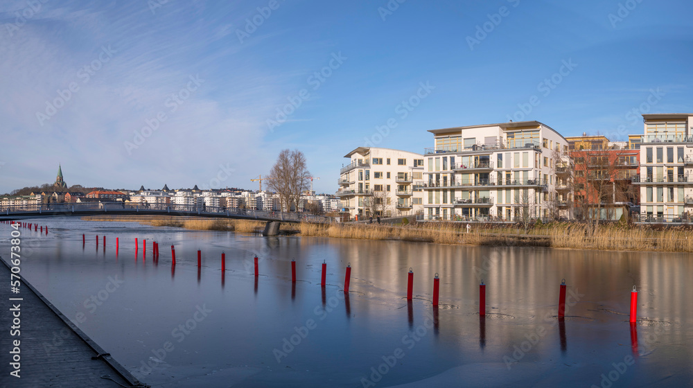 Obraz premium Panorama, waterfront apartment houses, canal and piers in the district Hammarby Sjöstad, a sunny winter day in Stockholm