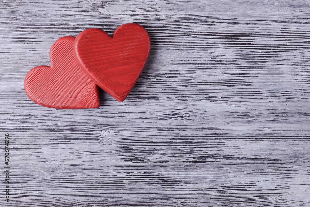 Two red Valentines hearts on aged wooden background with copy space Two red Valentines hearts on aged wooden background with copy space