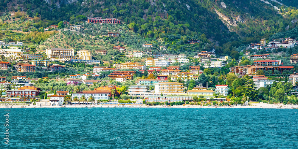 Limone Sul Garda, Italy - September 27, 2022: Village of Limone at Lake Garda, Lombardy, Italy. Colorful houses of Limone village. View from the ship.