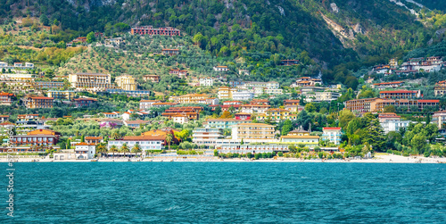 Limone Sul Garda  Italy - September 27  2022  Village of Limone at Lake Garda  Lombardy  Italy. Colorful houses of Limone village. View from the ship.