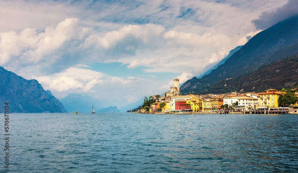 Malcesine, Italy. Ancient tower and fortress in the old town of Malcesine on Lake Garda, Veneto region, Italy. Summer landscape with colorful houses and beautiful sky. Veneto region, Italy. 