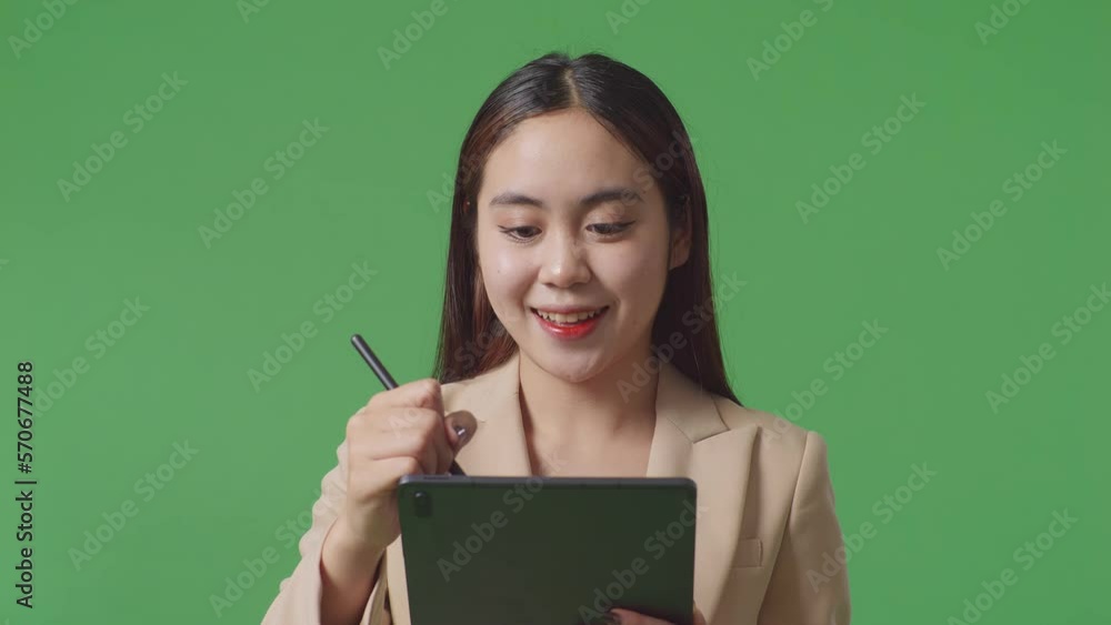 Close Up Of Asian Business Woman Writing Tablet On Green Screen Background In The Studio
Close Up Of Asian Business Woman Writing Tablet On Green Screen Background In The Studio
