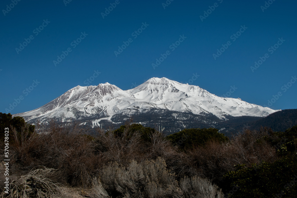 mountain with snow blue skies