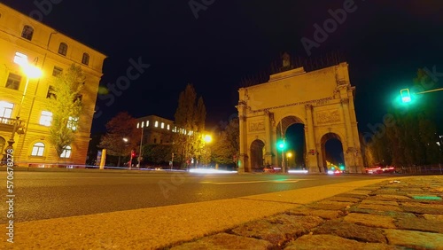 Low angle traffic speeding around Victory Arch Siegestor in central Munich, Germany. photo