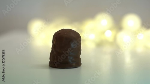 Krembo on a white surface. Blurred lights in the background. chocolate. photo