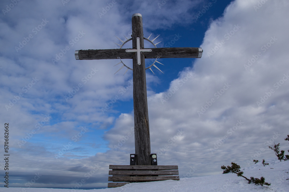 hölzernes Gipfelkreuz im winter vor weiß blauem Himmel hölzernes Gipfelkreuz im winter vor weiß blauem Himmel
