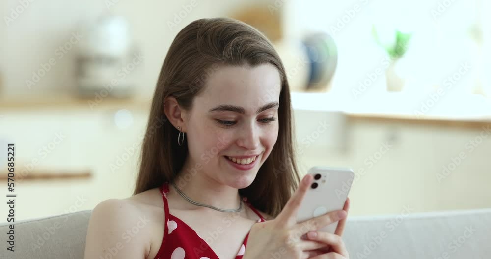 Close up beautiful smiling girl using smart phone, typing sms, share messages through messenger app, web surfing internet, spend free time in social media networks. Communication, modern tech usage Close up beautiful smiling girl using smart phone, typing sms, share messages through messenger app, web surfing internet, spend free time in social media networks. Communication, modern tech usage