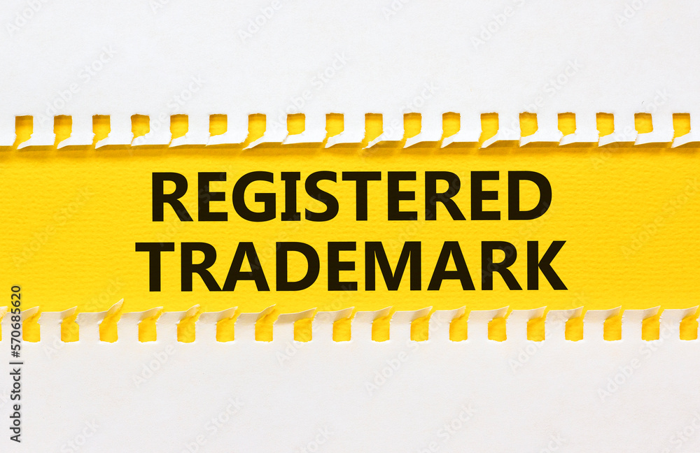 Obraz premium Registered trademark symbol. Concept word Registered trademark on yellow and white paper. Beautiful yellow and white background. Business and registered trademark concept. Copy space.