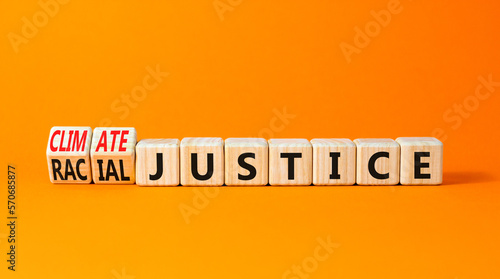 Climate or racial justice symbol. Concept words Climate justice Racial justice on wooden cubes. Beautiful orange table orange background. Ecological climate or racial justice concept. Copy space.