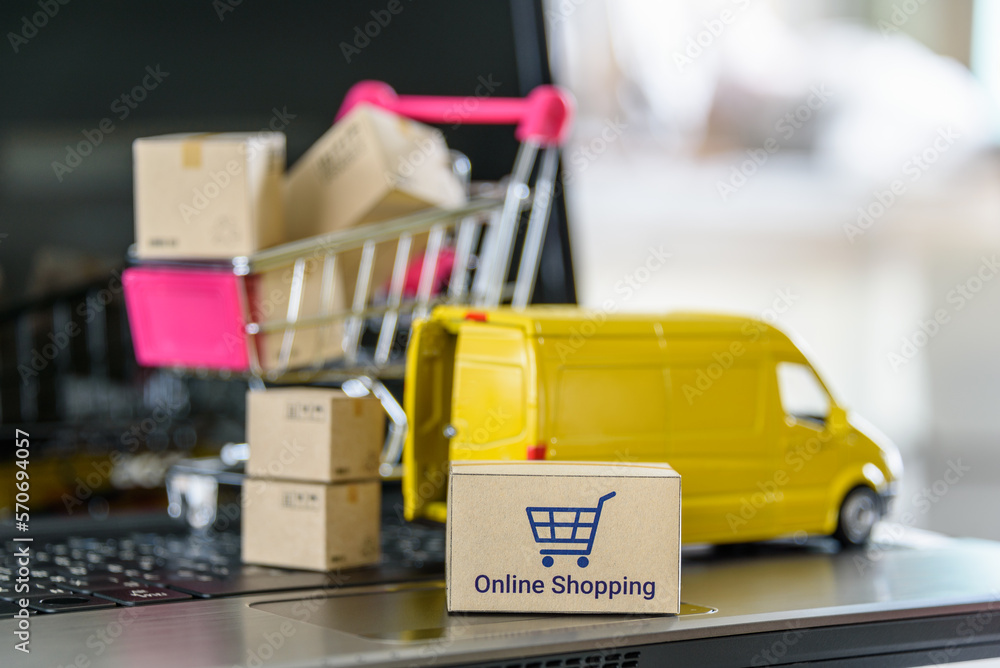 Online shopping, logistics, supply chain and shipment service, e-commerce concept : Boxes of goods, a shopping cart, delivery van on a laptop, depicting buyers place order or make purchases online. Online shopping, logistics, supply chain and shipment service, e-commerce concept : Boxes of goods, a shopping cart, delivery van on a laptop, depicting buyers place order or make purchases online.