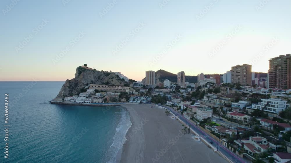 Benidorm Playa de Poniente beach at sunset during winter with tall buildings. Tourist city with skyscrapers. Benidorm Playa de Poniente beach at sunset during winter with tall buildings. Tourist city with skyscrapers.