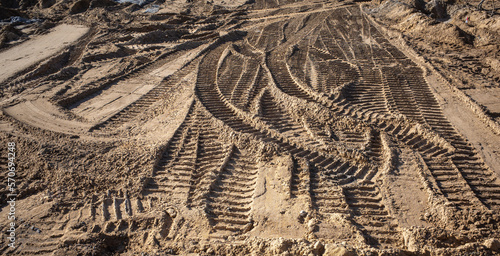 abstract image of tire tracks of construction vehicles in sand on a construction site