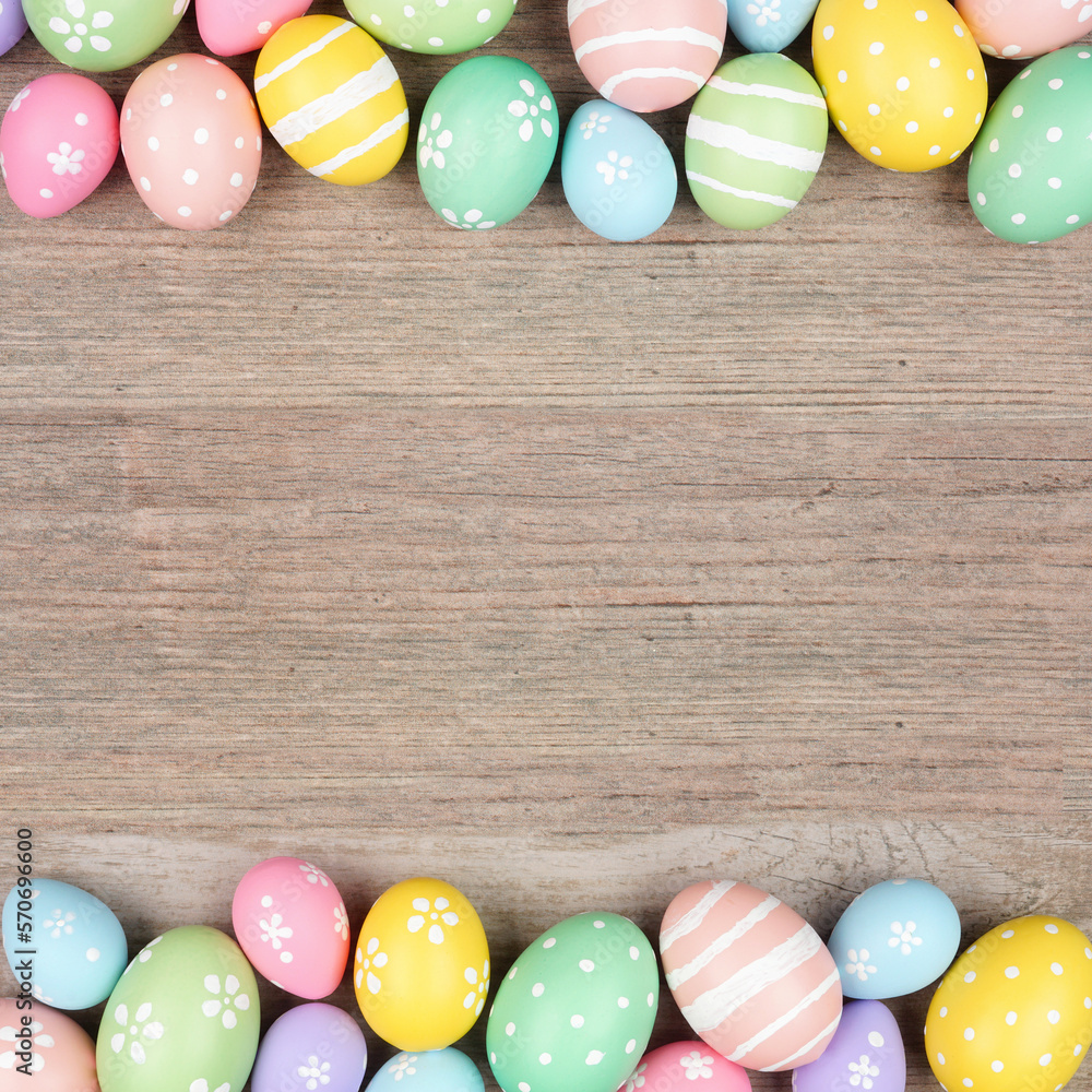 Colorful pastel Easter egg double border. Above view on a square, light wood background. Copy space.